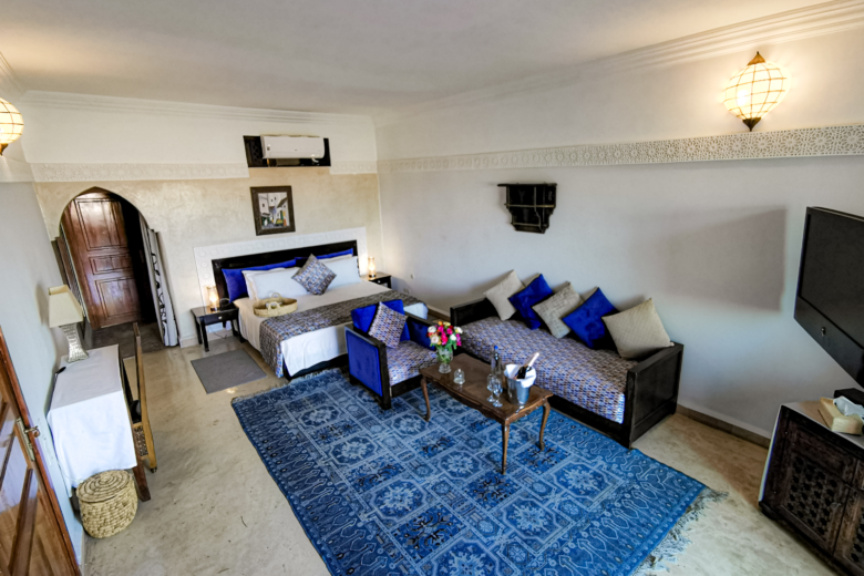 a room with two beds and a blue rug