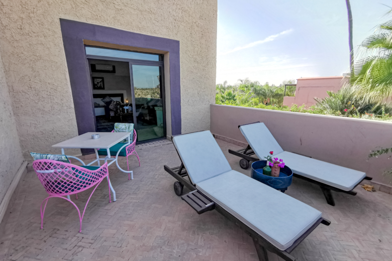 a patio with chairs and tables