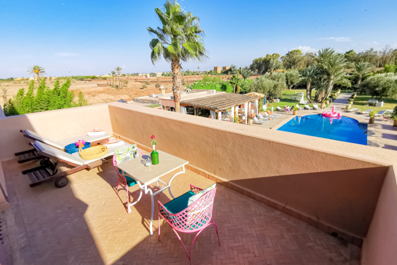 a patio with chairs and a pool