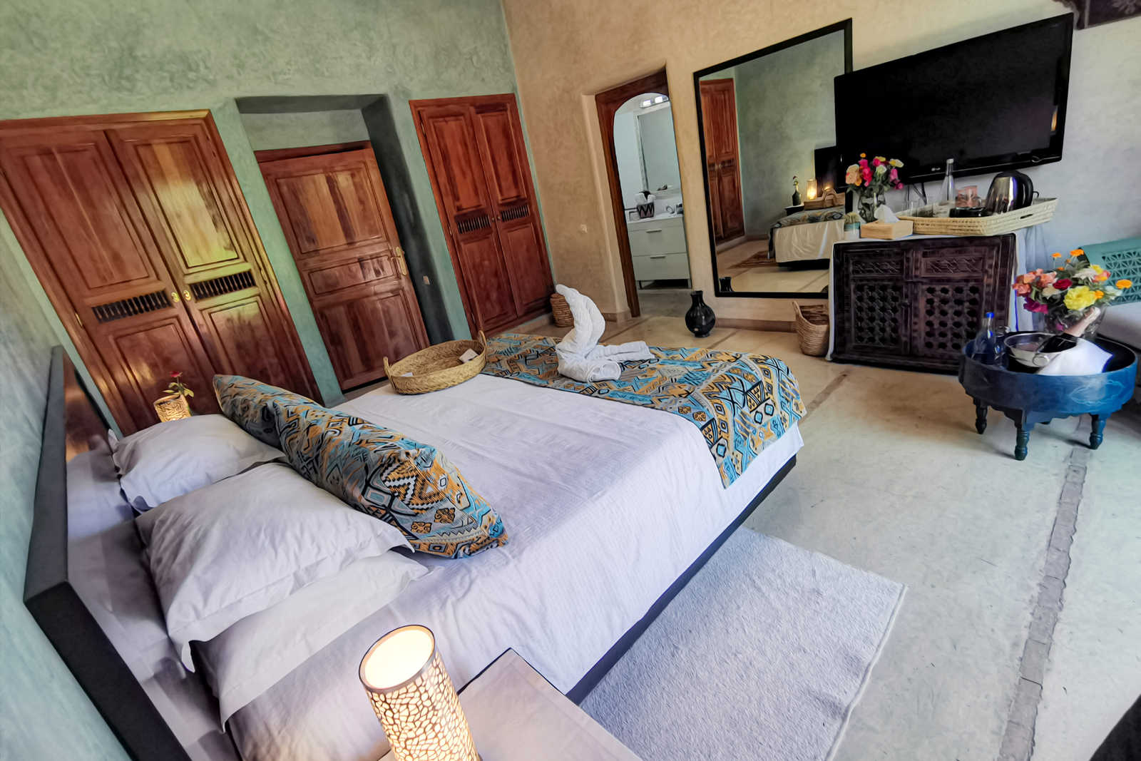 a bedroom with a large mirror and a bed