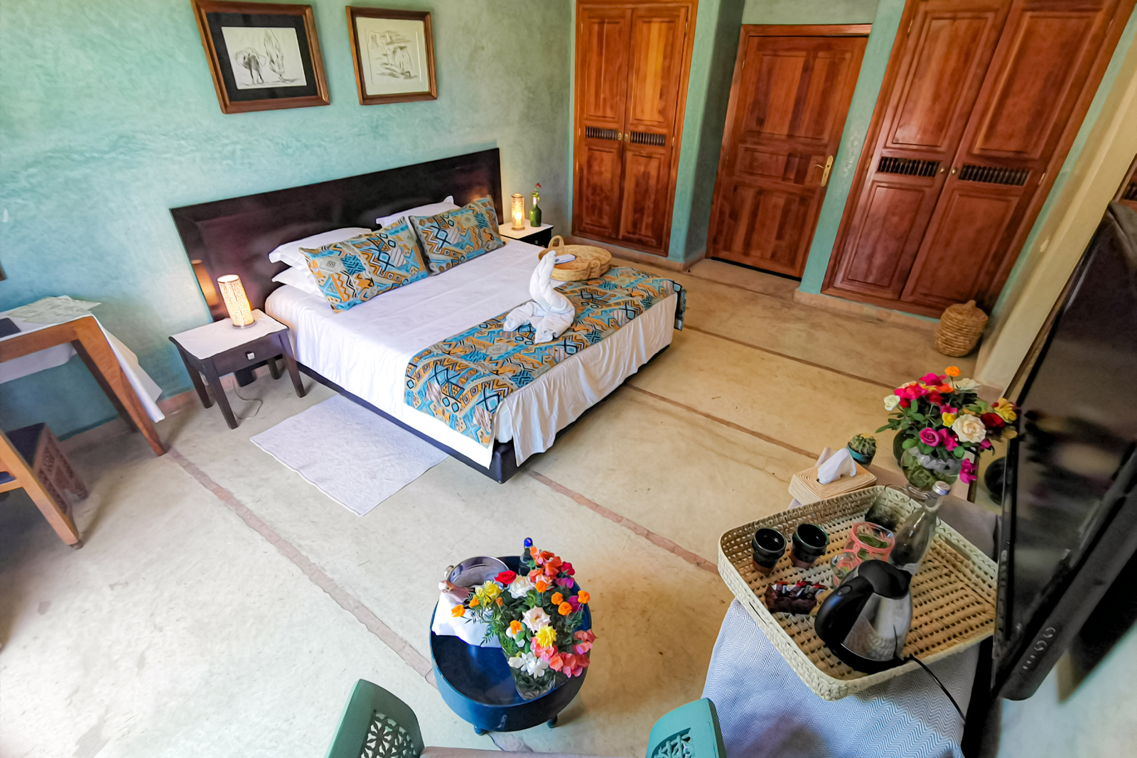 a room with a bed and a tray of flowers